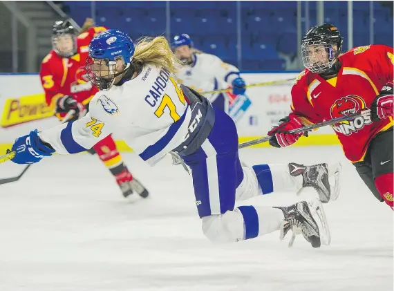  ?? — RICHARD LAM/UBC ATHLETICS ?? UBC Thunderbir­ds’ Kathleen Cahoon, left, is hooked by Calgary Dinos’ Madison Turk during Canada West women’s hockey action over the weekend at Doug Mitchell Arena. UBC swept two games from Calgary to improve to 2-1 on the season.