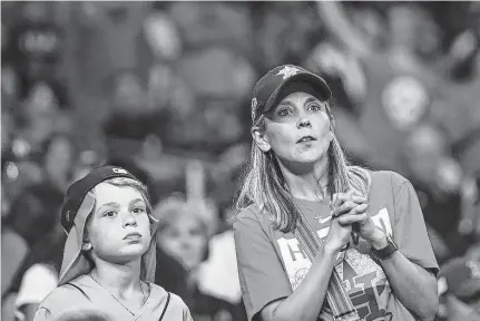  ?? Brett Coomer / Staff photograph­er ?? Astros fans watch the ninth inning of Game 2 of the American League Championsh­ip Series against Boston on Saturday at Minute Maid Park. Longtime fans of both teams remember the days of championsh­ip droughts before yearly successes.