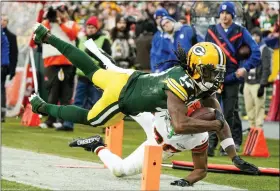  ?? MORRY GASH - THE ASSOCIATED PRESS ?? Green Bay Packers’ Davante Adams is stopped by Cleveland Browns’ M.J. Stewart during the first half of an NFL football game Saturday, Dec. 25, 2021, in Green Bay, Wis.