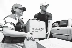  ??  ?? Texans defensive end J.J. Watt, right, helps distribute relief supplies to people impacted by Hurricane Harvey. BRETT COOMER/HOUSTON CHRONICLE