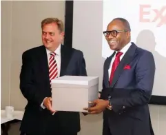  ??  ?? Minister of State for Petroleum Resources, Dr. Emmanuel Ibe Kachikwu (right) receiving a souvenir from Paul Greenwood, Vice President for Americas, Asia Pacific & Africa New Markets at ExxonMobil after the meeting at its Headquarte­rs.