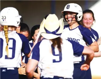  ?? STAFF PHOTOS BY ROBIN RUDD ?? Soddy-Daisy’s Courtney Sneed, right, smiles as approaches home plate after hitting a home run against Walker Valley on Monday. The visiting Lady Trojans beat Walker Valley 6-1.