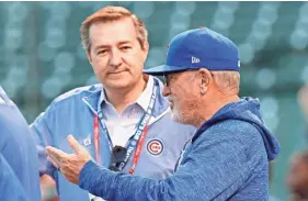  ??  ?? Chicago Cubs Chairman Tom Ricketts talks with manager Joe Maddon before Game 3 of the 2017 NLCS against the Dodgers. JIM YOUNG/USA TODAY SPORTS