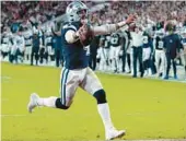  ?? JOHN RAOUX/AP ?? QB Dak Prescott runs for a TD during the Cowboys’ 31-14 playoff win over the Buccaneers on Monday night in Tampa, Florida. Prescott also tossed four TDs.