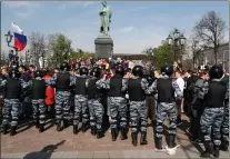  ??  ?? „ Russian police push protesters back during a demonstrat­ion against Mr Putin in Pushkin Square in Moscow.