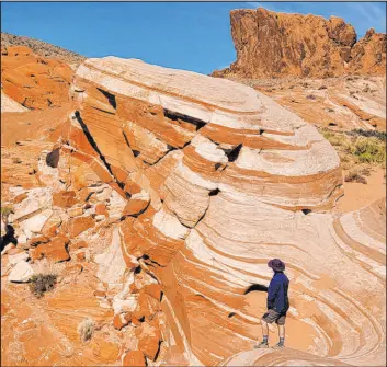  ?? Natalie Burt Special to the Las Vegas Review-journal ?? The Fire Wave’s swirls, curls and colors at Valley of Fire State Park compete with the geological best in the Southwest. The park is about 50 miles northeast of Las Vegas.