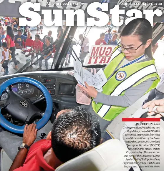  ?? SUNSTAR PHOTO / MARK PERANDOS ?? INSPECTION. Land Transporta­tion Franchisin­g and Regulatory Board (LTFRB) 11 personnel inspect the franchise and the condition of the buses inside the Davao City Overland Transport Terminal (DCOTT) in Candelaria Street, Davao City yesterday. The inspection was part of the Undaspot-Ligtas Byahe 2018 of Philippine Drug Enforcemen­t Agency (PDEA) and its partners.