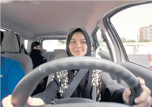  ??  ?? RIDING SUCCESS: A student at the female-only campus of Effat University, for the first time in the driver’s seat, for training sponsored by Ford, in Jiddah.