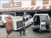  ?? Picture: DAVID MACGREGOR ?? END OF AN ERA: Workers remove a fridge from the legendary Beavers pie shop in Port Alfred yesterday