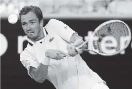  ?? ANDY BROWNBILL AP ?? Daniil Medvedev of Russia returns a shot by the Netherland­s’ Botic van de Zandschulp during their third-round match at the Australian Open on Saturday in Melbourne.