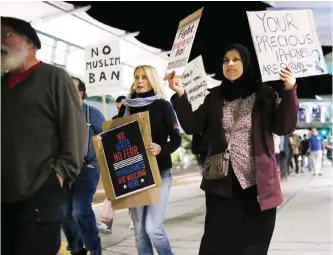  ??  ?? SAN DIEGO: Protesters chant during a rally against the travel ban at San Diego Internatio­nal Airport on Monday. — AFP