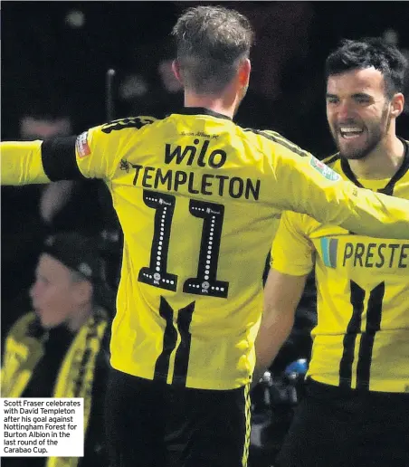  ??  ?? Scott Fraser celebrates with David Templeton after his goal against Nottingham Forest for Burton Albion in the last round of the Carabao Cup.