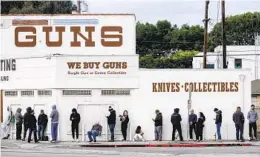  ?? RINGO H.W. CHIU AP FILE ?? People wait to enter a gun store in Culver City on March 15, 2020. The 9th U.S. Circuit Court of Appeals said gun store closures during the pandemic were illegal.