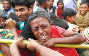  ??  ?? A ROHINGYA REFUGEE boy jostles for aid in Cox’s Bazar, Bangladesh in this Sept. 20 photo.