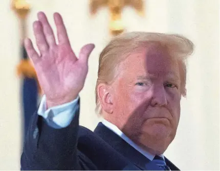  ?? ALEX BRANDON/ AP ?? President Donald Trump waves from the Blue Room Balcony upon returning to the White House Monday.