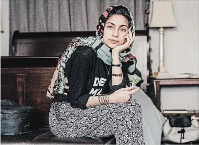  ?? WHITTEN SABBATINI NYT ?? Fashion blogger Hoda Katebi in her apartment in Chicago. Katebi is the brains behind the politicall­y charged fashion blog Joojoo Azad, in which she describes herself as a sarcastic (and angry) Muslim-Iranian creative and community organizer.