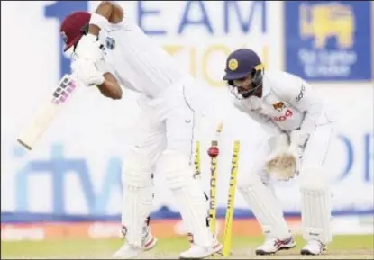  ?? ?? Shai Hope plays back to off-spinner Ramesh Mendis (out of picture) and is comprehens­ively bowled.