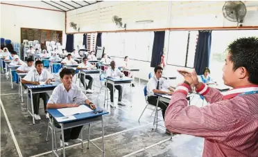  ??  ?? Schools provide special services to specially abled students, such as materials with enlarged prints and more time during exams to answer. — File photo