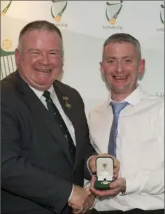  ??  ?? Stephen Johnson receives his award from Leinster Council chairman Jim Bolger.