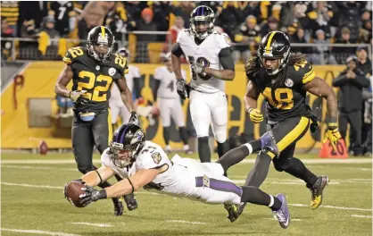 ??  ?? PITTSBURG: Baltimore Ravens fullback Kyle Juszczyk (44) dives into the end zone for a touchdown during the second half of an NFL football game against the Pittsburgh Steelers in Pittsburgh, Sunday. — AP