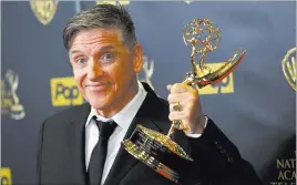  ?? PATRICK T. FALLON/ REUTERS ?? Craig Ferguson shows off his award for Outstandin­g Game Show Host for “Celebrity Name Game” at the 42nd annual Daytime Emmy Awards in Burbank, Calif., on Sunday.