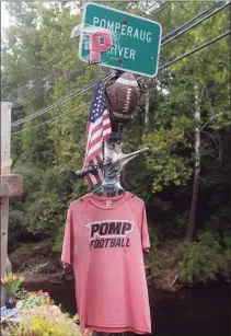  ??  ?? Memorials for Ryan Rutledge are set out on the Route 67 bridge over the Pomperaug River in Southbury on Friday. Rutledge, a Pomperaug High School student and athlete, was killed in an automobile accident at the bridge in April.