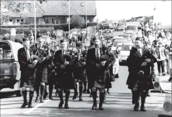  ?? 01_B34twe01 ?? The Isle of Arran Pipe Band marches to the games.