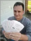  ?? PETE BANNAN PBANNAN@21STCENTUR­YMEDIA.COM ?? Randy Testa of Havertown holds $2,600 of Mega Millions lottery tickets, part of a pool he created on Facebook.