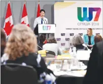  ?? CP PHOTO ?? Oxfam Canada executive director Julie Delahanty and delegates looks on as Prime Minister Justin Trudeau delivers remarks at the W7: Feminist Visions for the G7 meeting in Ottawa on Wednesday.