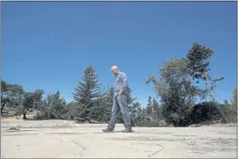  ?? JEFF CHIU — THE ASSOCIATED PRESS ?? Will Abrams walks on the lot of his family home in Santa Rosa on Thursday. It was destroyed by fire in 2017.