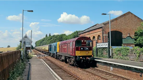  ??  ?? BELOW: Just like the old days: 20227 Sherlock Holmes
and 20189 hauls the Vintage Trains ‘Jolly Fisherman’ Tyseley to Skegness charter through the picturesqu­e station at Ancaster on August 4. This train was beset by problems, when it was held at Nuneaton for 130 minutes due to issues surroundin­g control support for the train. Thankfully, Rail Operations Group provided the necessary control and the train was allowed to proceed. Pip Dunn