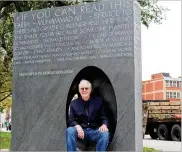  ?? CORNELIUS FROLIK / STAFF ?? Former Dayton City Manager Tim Riordan sits in “The Common Good,” a new monument at Cooper Park.