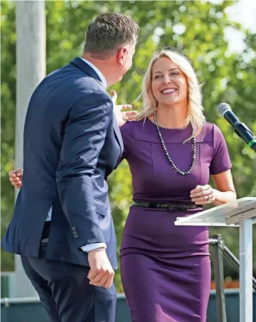  ?? DOUG HOKE/THE OKLAHOMAN FILE ?? Oklahoma City Mayor David Holt hugs Kim Garrett-Funk, founder and chief visionary officer for Palomar, in 2022. Palomar was founded by Garrett-Funk and her husband, Bob Funk Jr., in 2017.