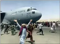  ?? VERIFIED UGC VIA AP ?? Hundreds of people run alongside a U.S. Air Force C-17 transport plane as it moves down a runway of the internatio­nal airport, in Kabul, Afghanista­n, Monday, Aug.16. 2021.