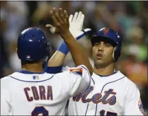  ?? KATHY WILLENS - THE ASSOCIATED PRESS ?? FILE - In this Tuesday, June 9, 2009 file photo, New York Mets Alex Cora (3) greets Carlos Beltran at the plate after Beltran’s third-inning two-run home run off Philadelph­ia Phillies pitcher J.A. Happ in a baseball game at Citi Field in New York.