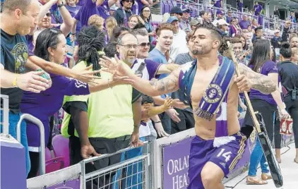  ?? REINHOLD MATAY/USA TODAY PHOTOS ?? Lions forward Dom Dwyer greets fans after Saturday’s win against New York. He donated his jersey in memory of fallen fan Miguel Vasquez.