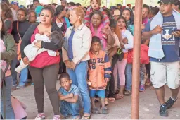  ?? NICK OZA/THE REPUBLIC ?? Central American migrants gather outside a church in Puebla, Mexico, hoping to join a caravan headed for the U.S.-Mexico border.