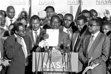  ??  ?? Odinga (centre) speaks during a news conference where he announces that he would not stand in a court-ordered re-run of August’s presidenti­al election that is scheduled for Oct 26 in Nairobi. — Reuters photo