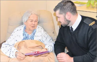  ?? TERRENCE MCEACHERN/THE GUARDIAN ?? HMCS Queen Charlotte unit public affairs officer Spencer Lee delivers a Valentine’s Day card to 98-year-old Blanche MacAleer on Monday at the Mount Continuing Care Community residence as part of the Valentines for Vets initiative.