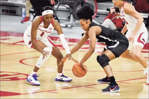  ?? Michael Woods / Associated Press ?? Arkansas forward Marquesha Davis, left, and UConn guard Christyn Williams go after a loose ball during the first half on Thursday.