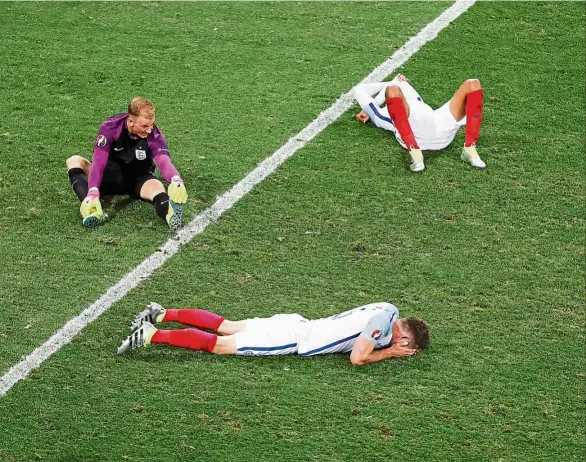  ??  ?? Out for the count: Goalkeeper Joe Hart looks dejected as two team-mates lie on the ground after England were knocked out by Iceland in the last 16 of the Euro 2016 at the nice Stadium on June 27. — Reuters