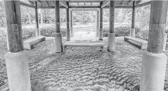  ?? Elizabeth Conley / Houston Chronicle ?? Sandy silt marks the pillars and fills the tea house on Storey Lake at Mercer Botanic Gardens. Storey Lake likely will have to be pumped out after damage from the April floods.