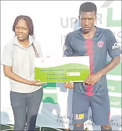  ?? (Pic: Ashmond Nzima) ?? Mbabane Swallows forward Ayanda Gadlela, who fired a hat-trick in the 4-0 thrashing of Madlenya at Mkhuzweni Technical Centre on Saturday, was the first recipient of the E1 000 Man of the Match prize following a partnershi­p with Upper Interiors. Four prizes will be given out each month. Giving out the prize is Upper Interiors’ Lwazi Malaza.