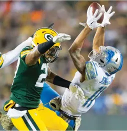  ?? (Reuters) ?? DETROIT LIONS receiver Marvin Jones Jr. (right) catches a pass in front of Green Bay Packers defender Josh Jones (center) during the second quarter at Lambeau Field on Monday night. Jones Jr. had seven receptions for 107 yards and two touchdowns as the...