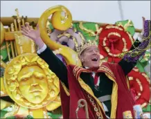  ??  ?? Actor Bryan Cranston waves beads as he acts as the celebrity monarch of the Krewe of Orpheus.