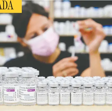  ?? NATHAN DENETTE / THE CANADIAN PRESS ?? Barbara Violo, pharmacist and owner of Toronto's Junction Chemist Pharmacy, prepares a COVID vaccine shot
on Friday. Canada is on track to have enough doses by the end of July to fully vaccinate every eligible Canadian.