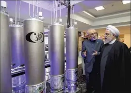  ?? Iranian Presidency ?? IRANIAN President Hassan Rouhani, right, meets nuclear experts in 2019. The U.S. is looking to revive the Iran nuclear deal that President Trump quit.