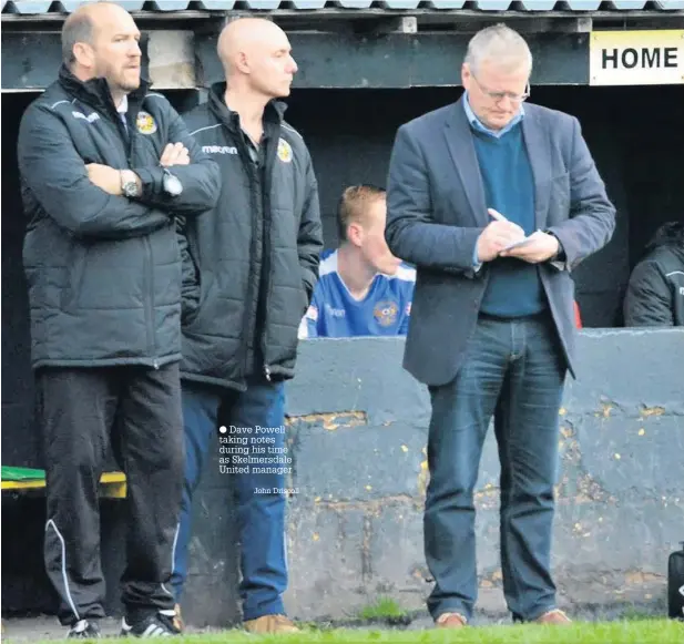  ?? Dave Powell taking notes during his time as Skelmersda­le United manager John Driscoll ??