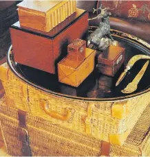  ?? BRYAN E. MCCAY ?? A stack of wicker suitcases is used to build a side table, adding to the earthy warmth of a study.