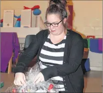  ?? SAM MCNEISH/THE TELEGRAM ?? Katie O’brien, director of The Children’s Centre in St. John’s, prepares an item for the 50th anniversar­y celebratio­n being hosted at Bally Haly tonight.